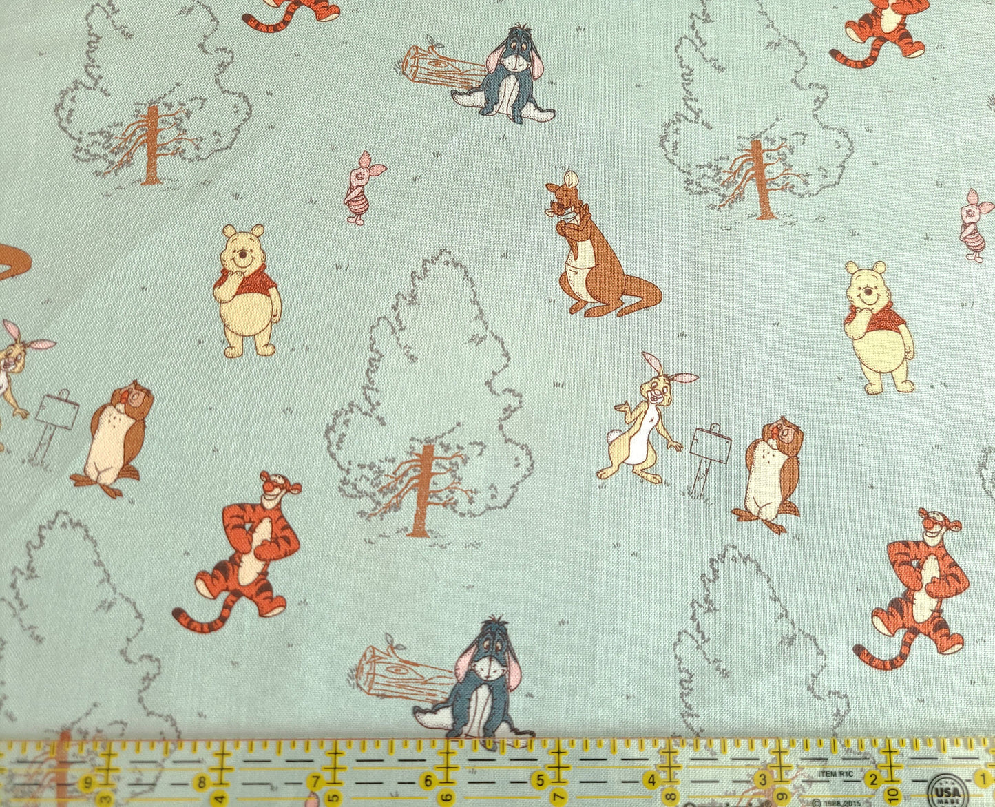 Disney Winnie The Pooh Group on Blue from Springs Creative 100% cotton fabric